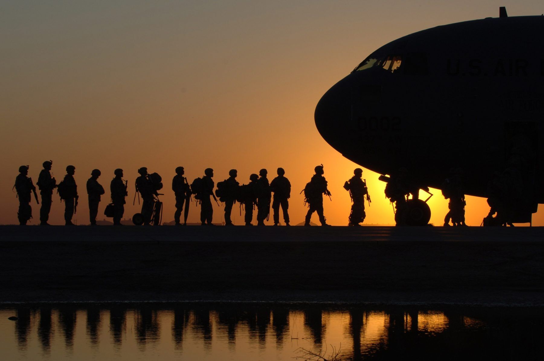 Soldiers boarding airplane