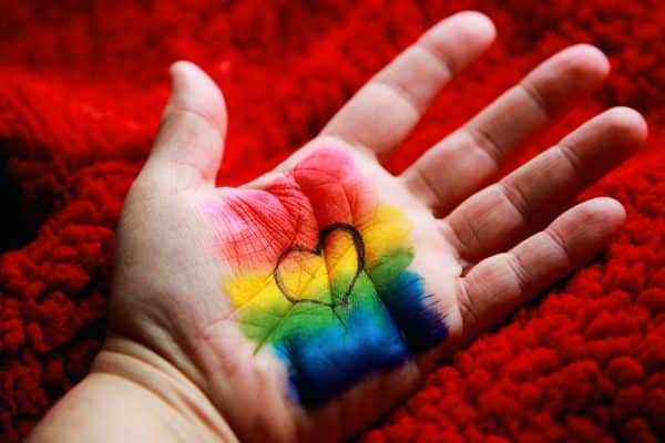Rainbow colors and heart on palm of hand