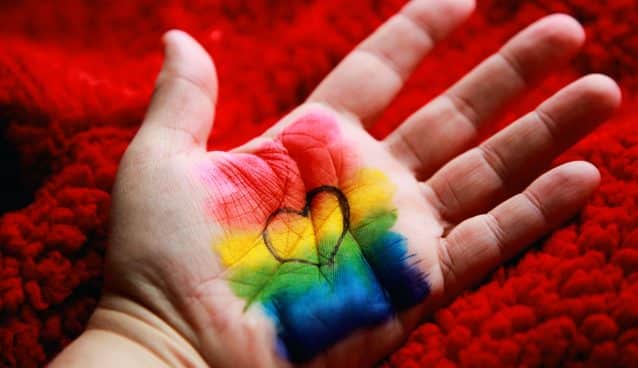 Rainbow colors and heart on palm of hand