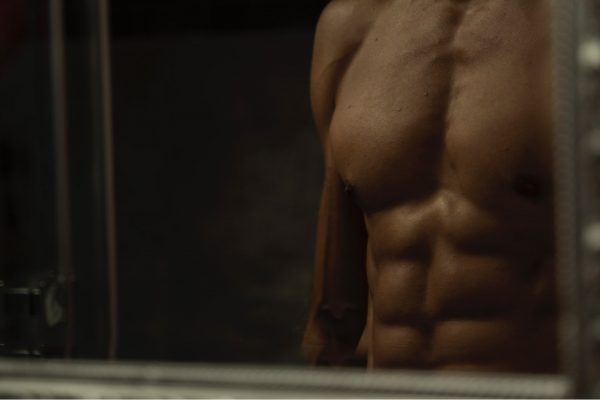 Male torso in mirror
