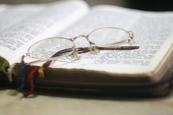 Glasses resting on Bible