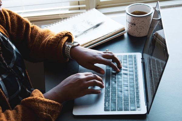 Person writing on laptop