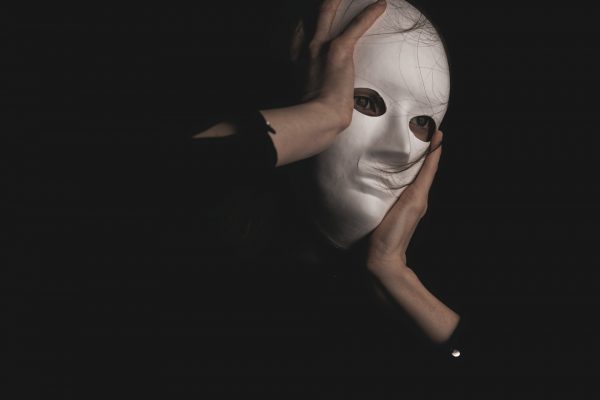 Person in black long sleeve shirt with white mask