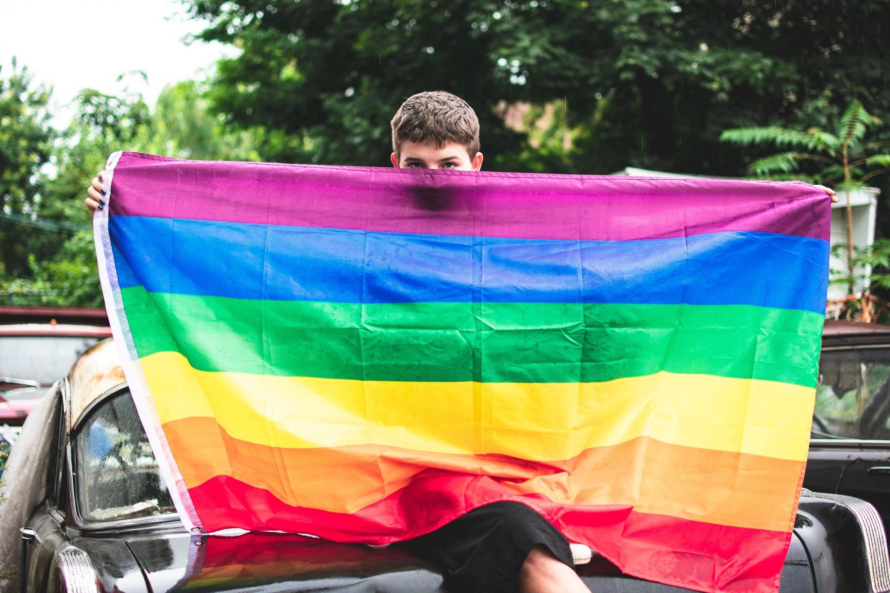 Boy holding Pride flag
