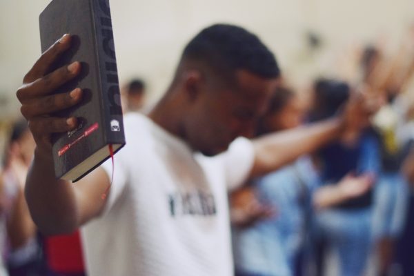 Praying man holding bible
