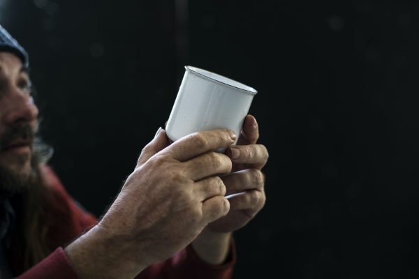 Man begging with cup