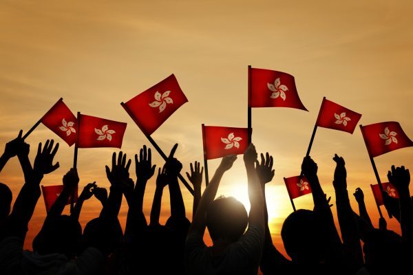 Silhouettes of People Holding the Flag of Hong Kong