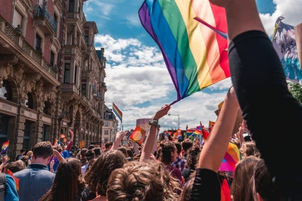 A crowd of people holding a pride flag