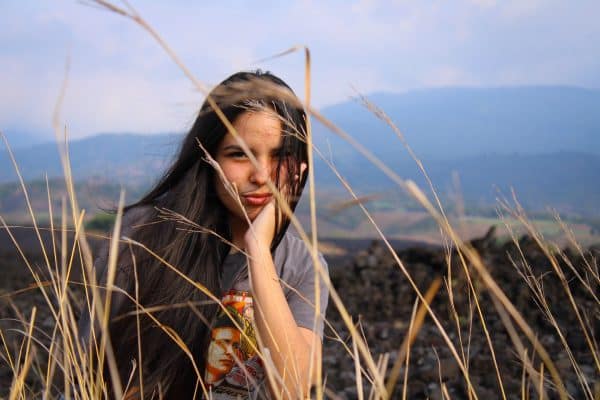 Dark-haired girl sitting in a field