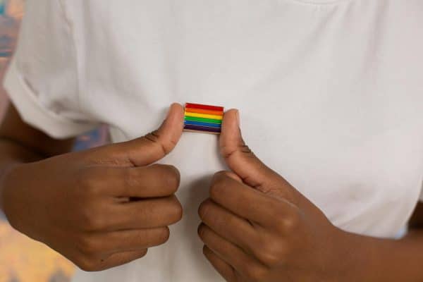 Close-up Photo of Rainbow Pin on White Shirt
