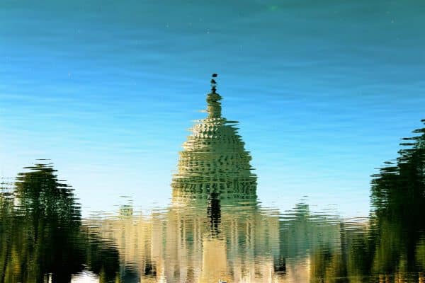 The U.S. Capitol reflected in water